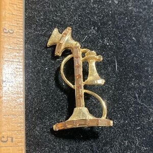 Vintagee candlestick telephone brooch.